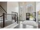 Staircase and foyer with lots of natural light, high ceilings, and opens to a home office through sliding glass doors at 1460 Lakemist Ct, Roswell, GA 30075