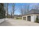 Spacious three-car garage with a wide driveway, situated in a well-maintained neighborhood with mature trees and landscaping at 1460 Lakemist Ct, Roswell, GA 30075