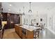Gourmet kitchen boasts a large island, granite countertops, stainless appliances, and a cozy breakfast nook with bright windows at 1460 Lakemist Ct, Roswell, GA 30075