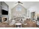 Bright living room with a fireplace, high ceilings, and neutral decor; natural light streams in from large windows at 1460 Lakemist Ct, Roswell, GA 30075