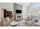 A comfortable living room with a fireplace, hardwood floors, and views to the kitchen and outside at 1460 Lakemist Ct, Roswell, GA 30075