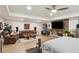 An open-concept bedroom and living room area featuring a fireplace, ceiling fan, and comfortable seating at 1460 Lakemist Ct, Roswell, GA 30075