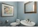Charming powder room with stylish fixtures, soothing colors, and elegant decor; adds convenience and sophistication to the home at 1460 Lakemist Ct, Roswell, GA 30075