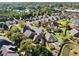 Aerial view of a neighborhood showcasing homes with mature trees and landscaping at 2528 Picket Fence Ln, Snellville, GA 30078