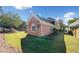 Backyard view of brick home with lawn at 2528 Picket Fence Ln, Snellville, GA 30078