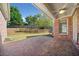 Covered patio, brick flooring, ceiling fan, and brick elevation enhance this backyard at 2528 Picket Fence Ln, Snellville, GA 30078