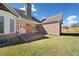 Expansive backyard with a brick patio and lush green lawn under a sunny sky at 2528 Picket Fence Ln, Snellville, GA 30078