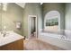 Bathroom features tub, separate sink vanity, and neutral paint at 2528 Picket Fence Ln, Snellville, GA 30078
