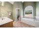 Bathroom with soaking tub under window and separate toilet room at 2528 Picket Fence Ln, Snellville, GA 30078