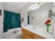 Bathroom featuring a shower/tub combo with a tile floor and wood vanity at 2528 Picket Fence Ln, Snellville, GA 30078