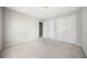 This is a bedroom with neutral walls, a light-colored carpet, and double closets at 2528 Picket Fence Ln, Snellville, GA 30078