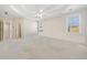 Spacious bedroom with tray ceiling, ceiling fan, and neutral carpet at 2528 Picket Fence Ln, Snellville, GA 30078