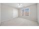 Neutral room features a carpeted floor, window, and closet at 2528 Picket Fence Ln, Snellville, GA 30078