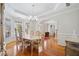 Open dining room showcasing hardwood floors, chandelier, and lots of natural light at 2528 Picket Fence Ln, Snellville, GA 30078
