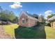 Charming brick home with a well-manicured lawn and mature trees at 2528 Picket Fence Ln, Snellville, GA 30078