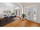 Staged foyer with hardwood floors, elegant chandelier, table and chairs at 2528 Picket Fence Ln, Snellville, GA 30078
