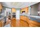 Modern kitchen with stainless steel appliances, wooden cabinets, and hardwood floors at 2528 Picket Fence Ln, Snellville, GA 30078