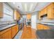 Modern kitchen with hardwood floors, wooden cabinets, and stainless steel appliances at 2528 Picket Fence Ln, Snellville, GA 30078