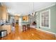 Open kitchen featuring wood cabinets, bar stool seating, and hardwood floors at 2528 Picket Fence Ln, Snellville, GA 30078
