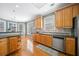 Spacious kitchen featuring wooden cabinets, stainless steel appliances, and a breakfast bar at 2528 Picket Fence Ln, Snellville, GA 30078