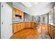 Well-lit kitchen with hardwood floors, wooden cabinets, and stainless steel appliances at 2528 Picket Fence Ln, Snellville, GA 30078