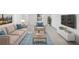 Living room featuring neutral-toned furniture, and a bright area rug on top of neutral carpet at 2528 Picket Fence Ln, Snellville, GA 30078