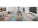 Inviting living room with a comfortable sofa, stylish rug, and a mounted television at 2528 Picket Fence Ln, Snellville, GA 30078