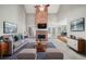 Comfortable living room with a brick fireplace, modern furniture, and stylish decor at 2528 Picket Fence Ln, Snellville, GA 30078