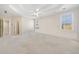Spacious main bedroom with tray ceiling, carpet floors, and natural light from dual windows at 2528 Picket Fence Ln, Snellville, GA 30078