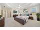 Decorated main bedroom featuring a tray ceiling, carpeting, and natural lighting at 2528 Picket Fence Ln, Snellville, GA 30078
