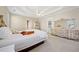 Bright main bedroom features tray ceiling, ceiling fan, and elegant furnishings at 2528 Picket Fence Ln, Snellville, GA 30078