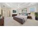 Well-appointed main bedroom features TV, dresser, king bed, and bedside tables at 2528 Picket Fence Ln, Snellville, GA 30078