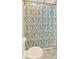 Bathroom with a toilet, patterned shower curtain, and marble floors at 2855 Peachtree Ne Rd # 302, Atlanta, GA 30305