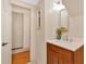 Bathroom with a wood vanity, marble countertops, and a view into the hallway at 2855 Peachtree Ne Rd # 302, Atlanta, GA 30305