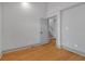 Cozy bedroom featuring wood floors, neutral paint, and a doorway leading to stairs at 2855 Peachtree Ne Rd # 302, Atlanta, GA 30305