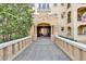 Beautiful building entrance with stone walkway, lush landscaping, and classic architectural details at 2855 Peachtree Ne Rd # 302, Atlanta, GA 30305