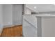 Hallway with a railing, gray walls, hardwood floors, and a view of the lower level at 2855 Peachtree Ne Rd # 302, Atlanta, GA 30305