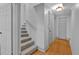 Hallway featuring carpeted stairs, wood floors, white walls, and white doors at 2855 Peachtree Ne Rd # 302, Atlanta, GA 30305