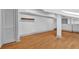 Bright living room featuring hardwood floors, neutral gray walls, modern recessed lighting and new door at 2855 Peachtree Ne Rd # 302, Atlanta, GA 30305