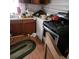 Dated kitchen features a gas stove, red teakettle and messy countertop at 1092 Victory Dr, Atlanta, GA 30310