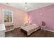 Cozy bedroom with hardwood floors, a charming chandelier, and natural light at 1760 Clayton Cir, Cumming, GA 30040