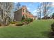 Side view of charming two-story brick home with a lush green lawn at 1760 Clayton Cir, Cumming, GA 30040