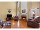 Spacious living room featuring a brick fireplace, hardwood floors, and large windows at 1760 Clayton Cir, Cumming, GA 30040