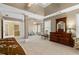 Expansive main bedroom features a tray ceiling, sitting area, and windows providing natural light at 1760 Clayton Cir, Cumming, GA 30040