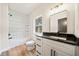 Bathroom with modern vanity, white cabinets, dark countertop, and a subway tiled shower at 2788 Browns Mill Se Rd, Atlanta, GA 30354