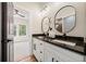 Bathroom with double sink vanity featuring granite counters and modern fixtures at 2788 Browns Mill Se Rd, Atlanta, GA 30354