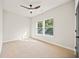 Cozy bedroom with a ceiling fan, multiple windows providing natural light and dark door accents at 2788 Browns Mill Se Rd, Atlanta, GA 30354