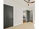 Bedroom showcasing closet doors and open bathroom doorway with neutral walls and carpet at 2788 Browns Mill Se Rd, Atlanta, GA 30354