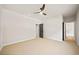 Bedroom featuring neutral carpet and paint with a modern ceiling fan and views to an en-suite bathroom at 2788 Browns Mill Se Rd, Atlanta, GA 30354