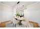 Elegant dining room with modern lighting and wainscoting, with a view into the kitchen at 2788 Browns Mill Se Rd, Atlanta, GA 30354